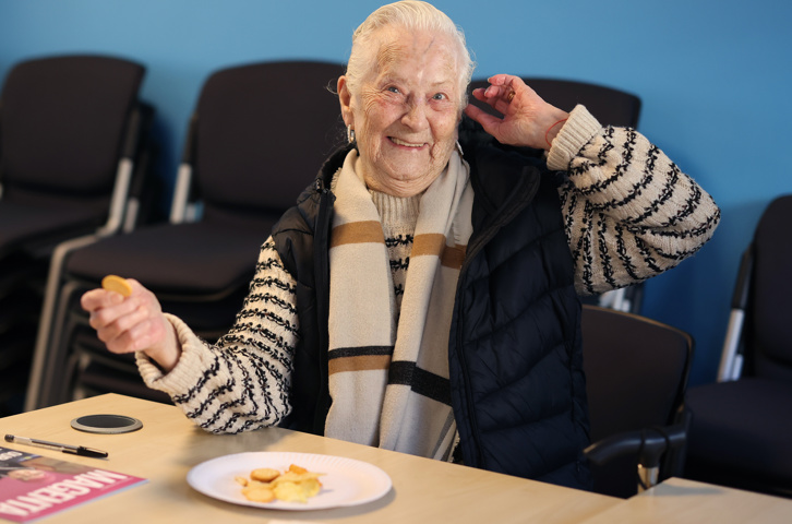 Customer enjoying refreshments at a group session in a bright room.