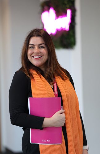 Portrait female staff member with magenta folder