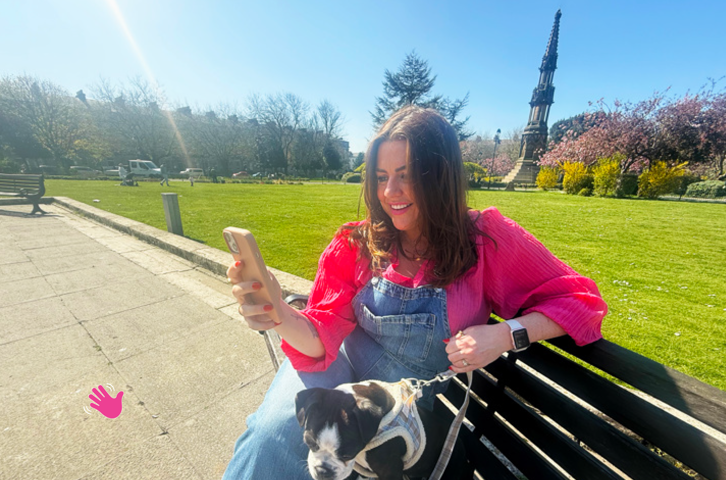 A woman on their phone smiling