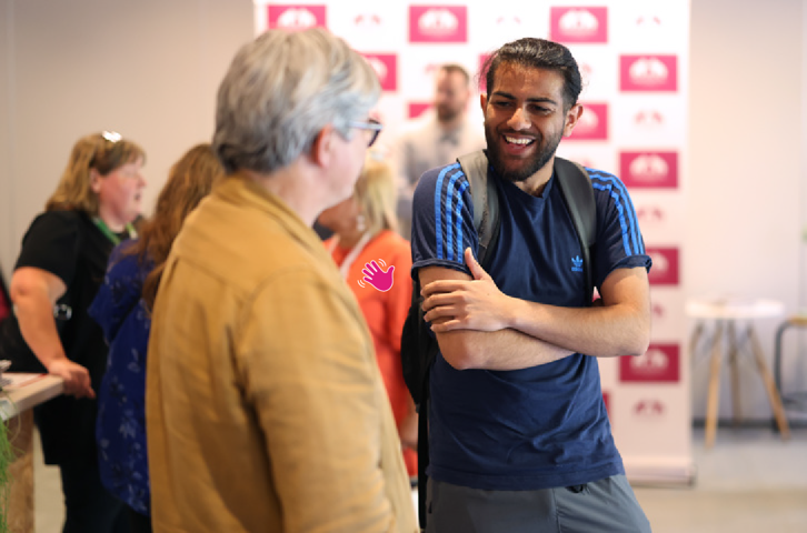 Two men laughing with each other.