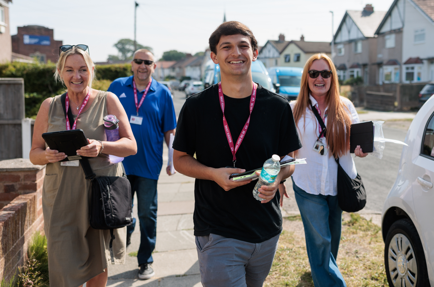 Four Magenta Living colleagues smiling when out in the community for the Big Door Knock event