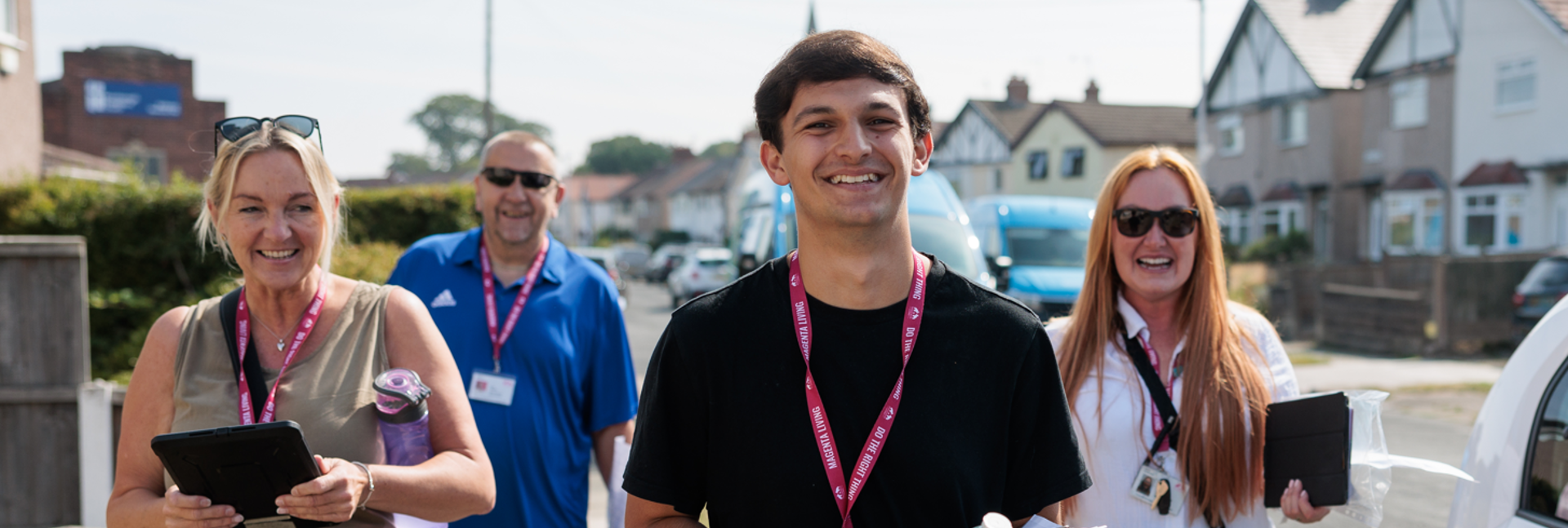 Four Magenta Living colleagues smiling when out in the community for the Big Door Knock event