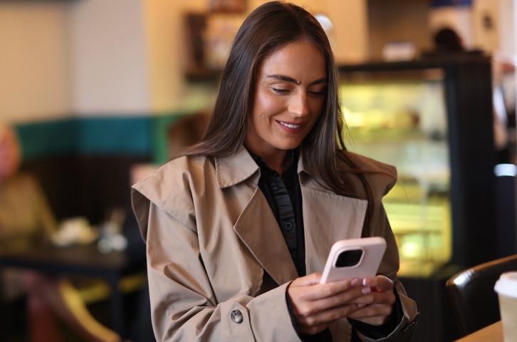 Person using a smartphone to access information online.