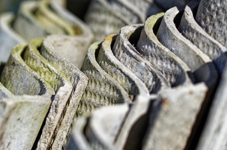 Stack of corrugated asbestos cement sheets viewed close up