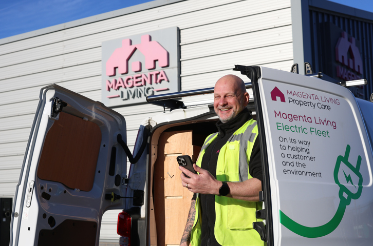 Colleague next to Magenta Living van