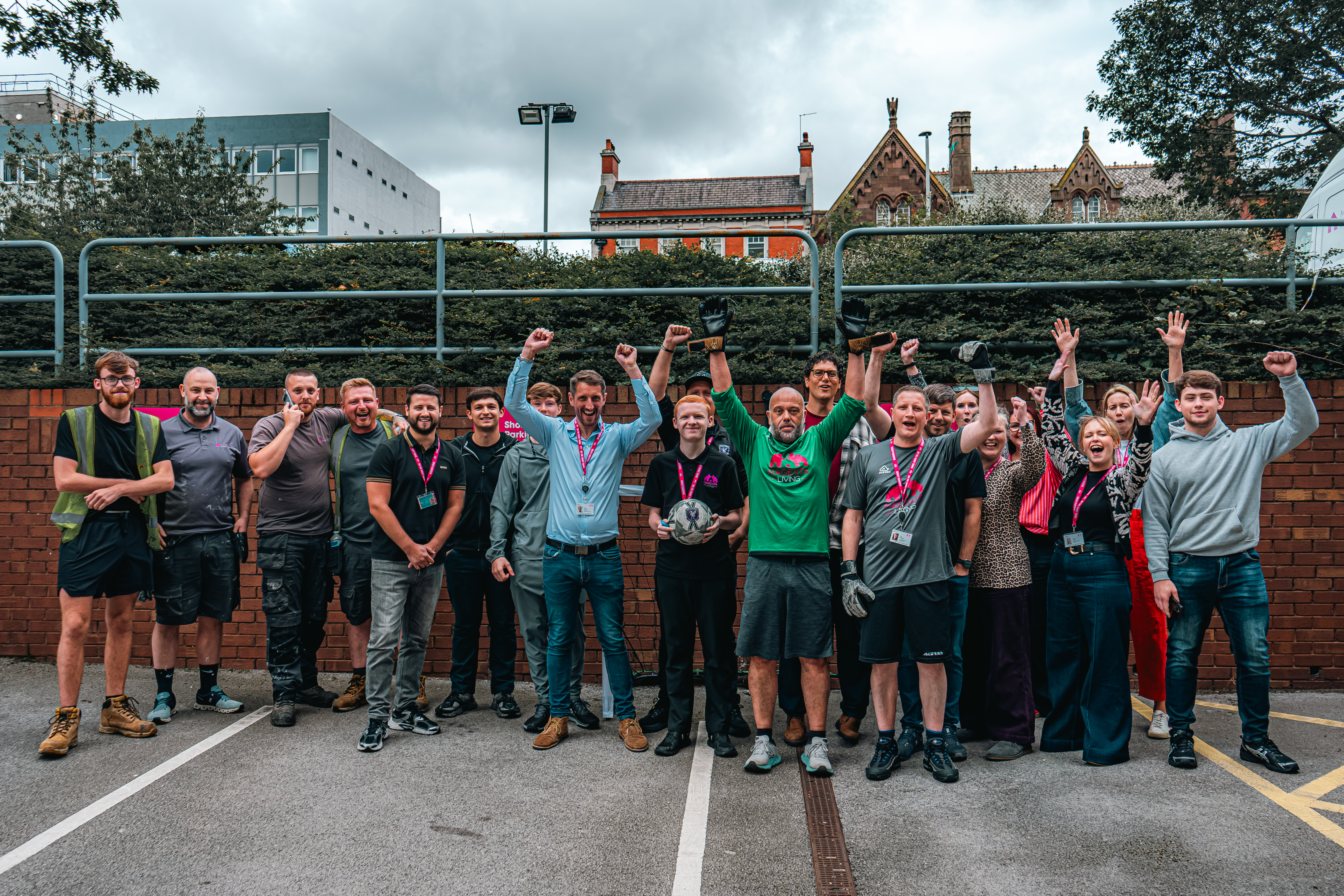 Colleagues taking part in the 'Beat the Keeper' challenge at Magenta Living's World Cup fundraising event, gathered together after the activity.