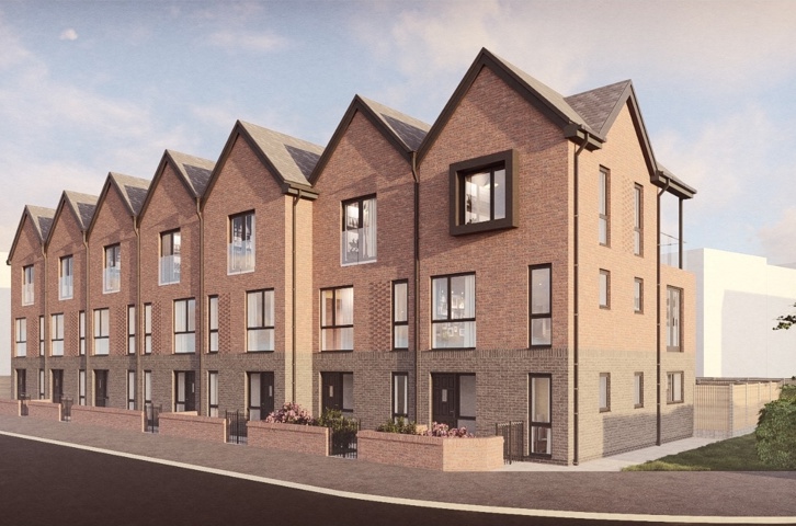 New terraced brick homes with tall windows and small planted areas at the front.