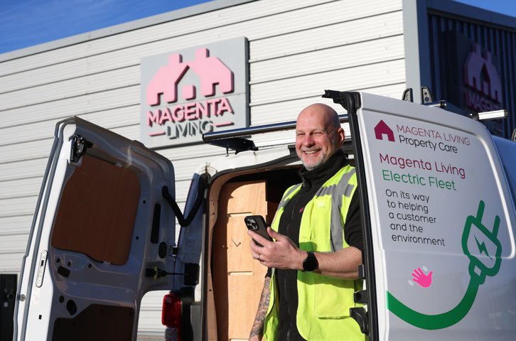 Colleague outside property care van holding phone