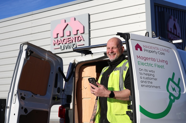 Colleague outside property care van holding phone