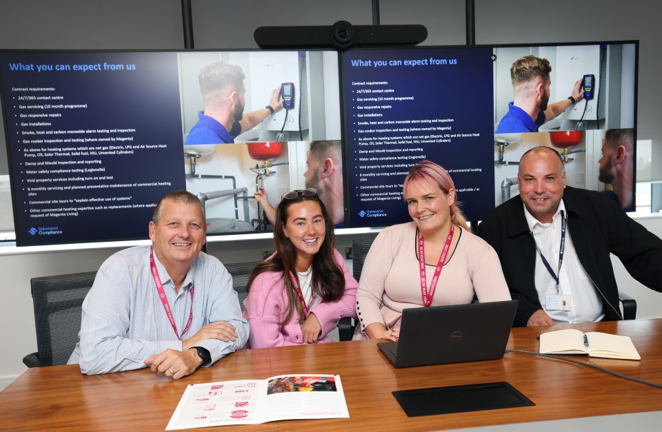 Colleagues and customers seated in a meeting room with presentation screens displaying repair and service details.