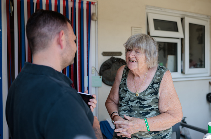 Magenta Living colleague speaking with a customer during a neighbourhood visit.