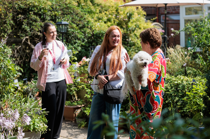 Magenta Living Colleagues talking in a residents garden