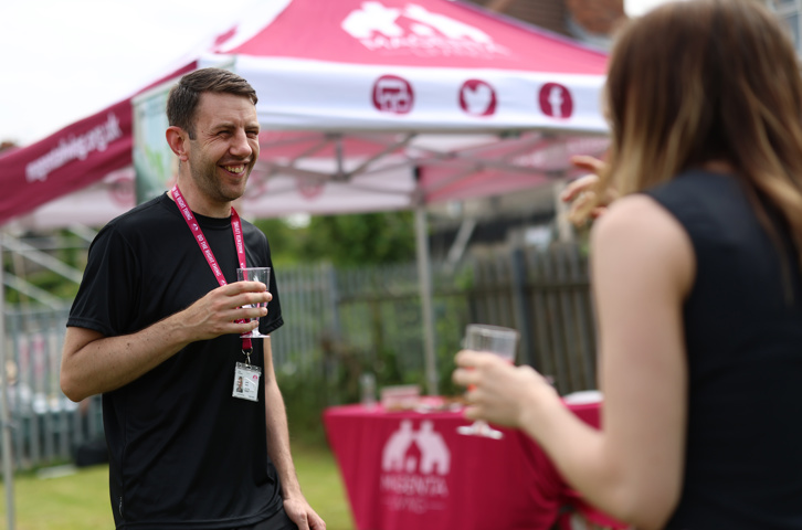 Two people chatting at an outdoor Jobs Plus event.